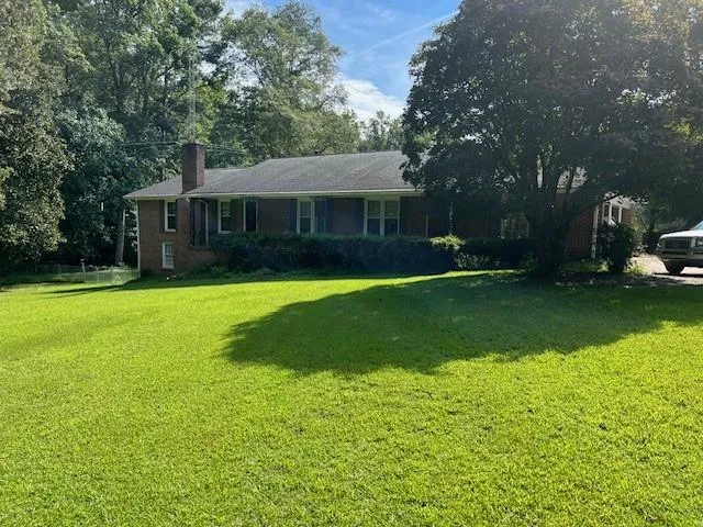 a view of a house with a yard porch and sitting area