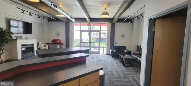 a view of a chair and table in backyard of the house
