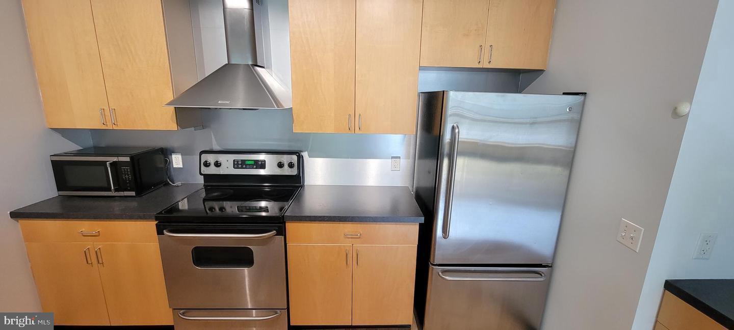 75 Maple Street, Unit 202 Conshohocken, PA 19428 - Photo 7 of 36 a kitchen with a refrigerator and a stove