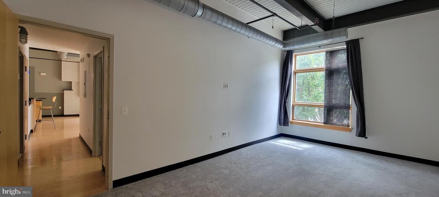 75 Maple Street, Unit 202 Conshohocken, PA 19428 - Photo 10 of 36 a view of a hallway with wooden floor and a living room