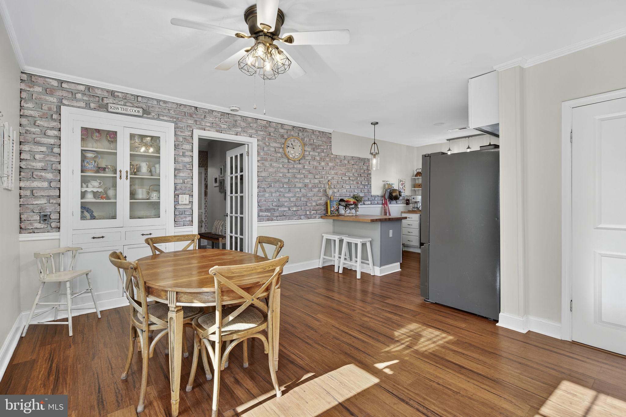 18321 Carrico Mills Road Stevensburg, VA 22741 - Photo 19 of 62 a dining room with furniture a chandelier and wooden floor