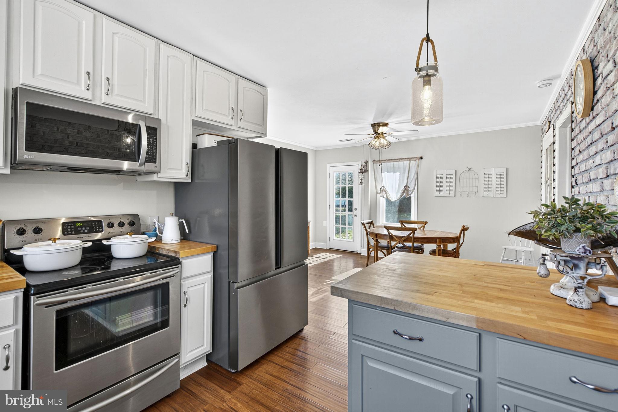 18321 Carrico Mills Road Stevensburg, VA 22741 - Photo 25 of 62 a kitchen with granite countertop a sink stainless steel appliances and cabinets