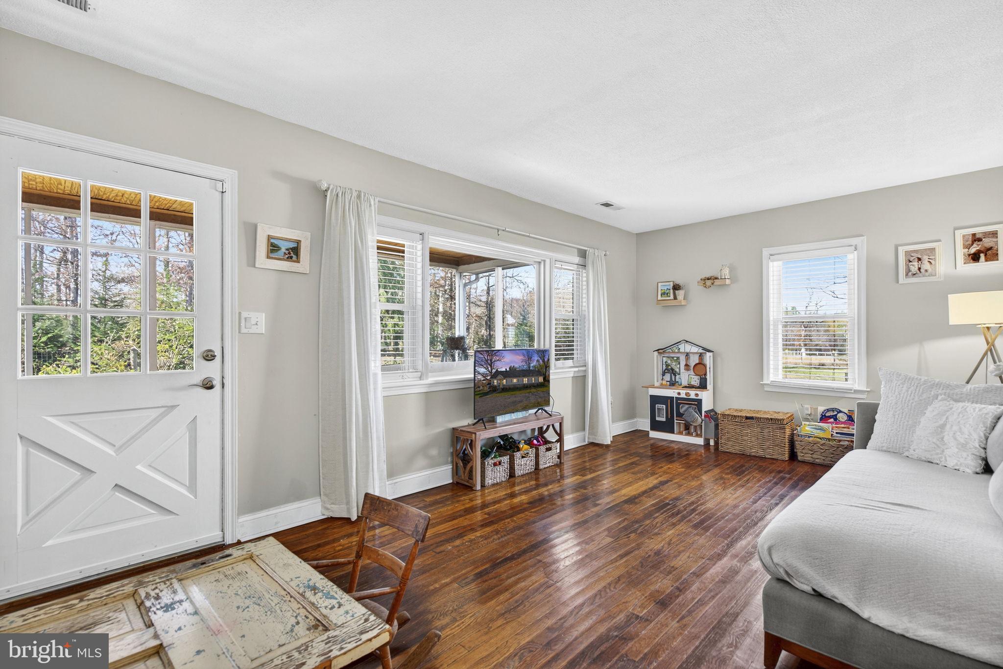 18321 Carrico Mills Road Stevensburg, VA 22741 - Photo 29 of 62 a living room with furniture and wooden floor