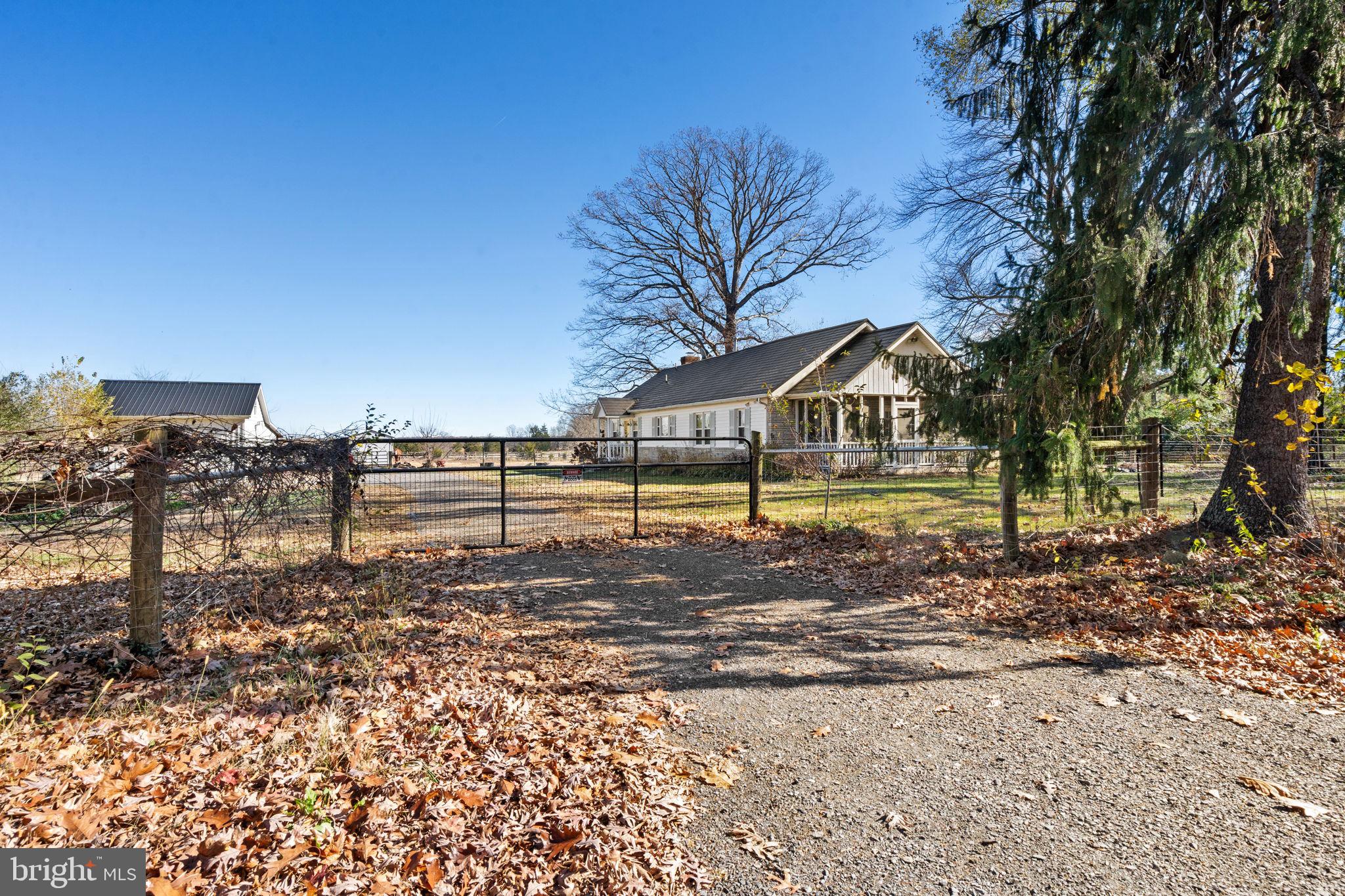 18321 Carrico Mills Road Stevensburg, VA 22741 - Photo 3 of 62 a view of a yard with wooden fence