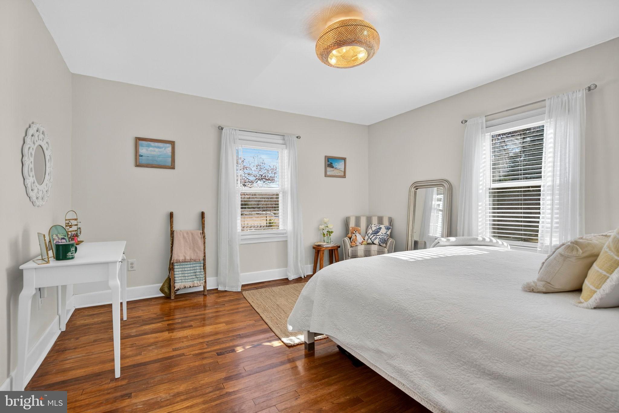 18321 Carrico Mills Road Stevensburg, VA 22741 - Photo 32 of 62 a bedroom with a bed and wooden floor