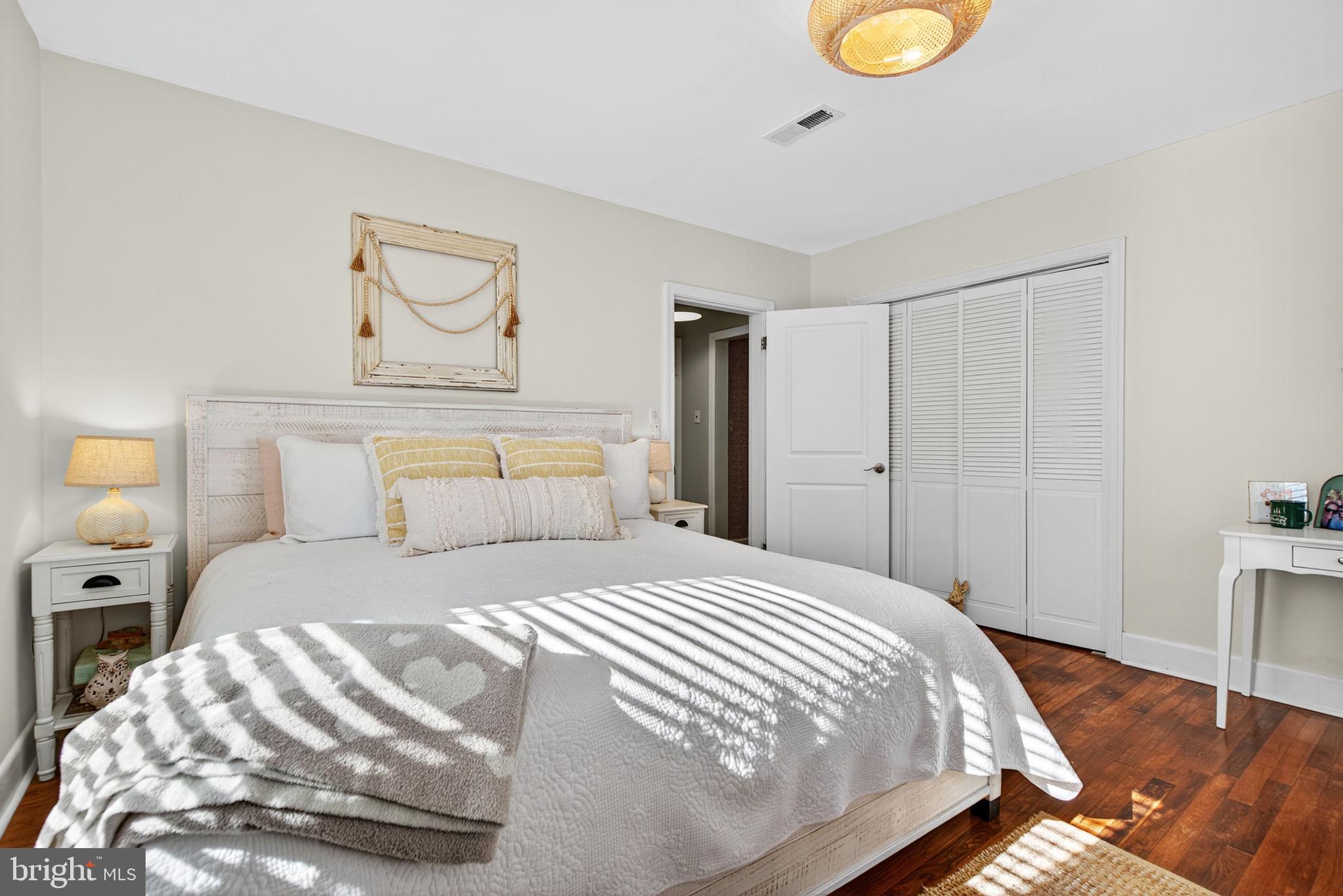 18321 Carrico Mills Road Stevensburg, VA 22741 - Photo 34 of 62 a bedroom with a bed and lamps