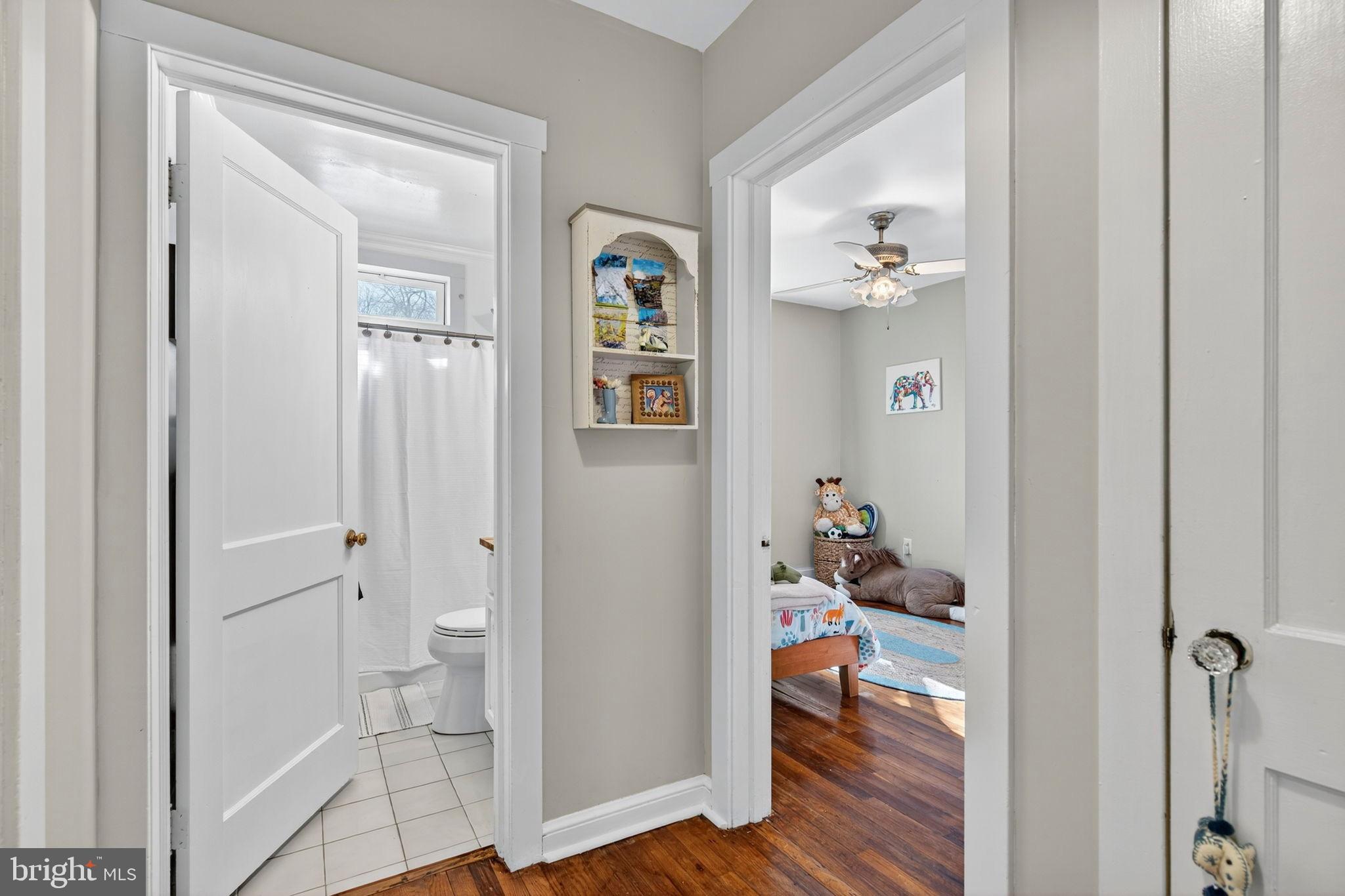 18321 Carrico Mills Road Stevensburg, VA 22741 - Photo 35 of 62 a view of a hallway with wooden floor and a bedroom