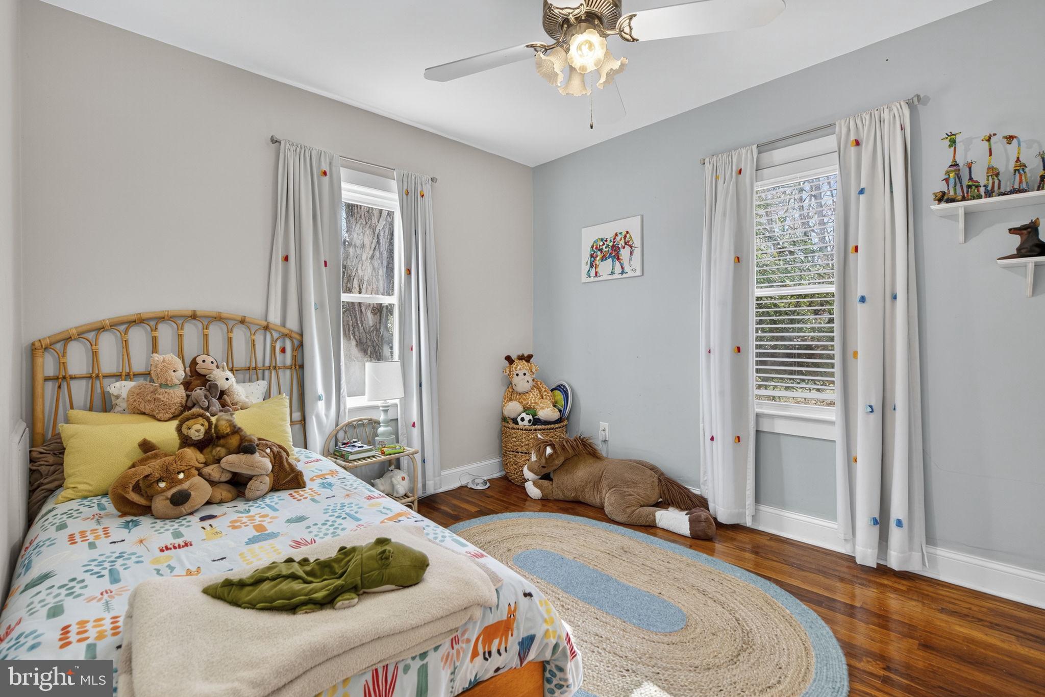 18321 Carrico Mills Road Stevensburg, VA 22741 - Photo 37 of 62 a bedroom with a bed and wooden floor
