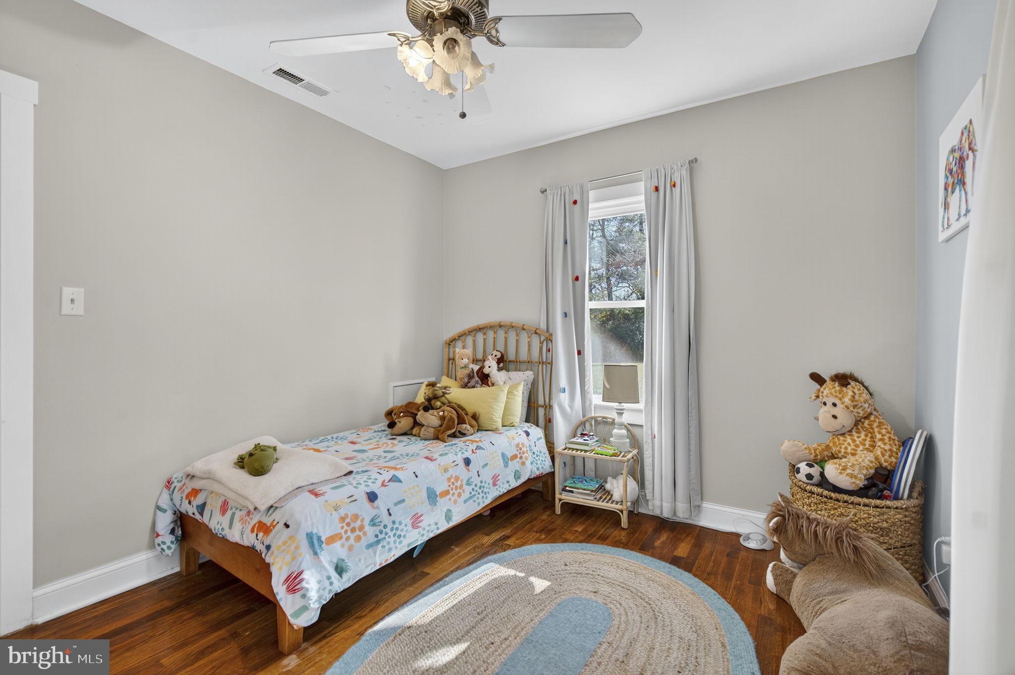 18321 Carrico Mills Road Stevensburg, VA 22741 - Photo 38 of 62 a bedroom with a bed and wooden floor