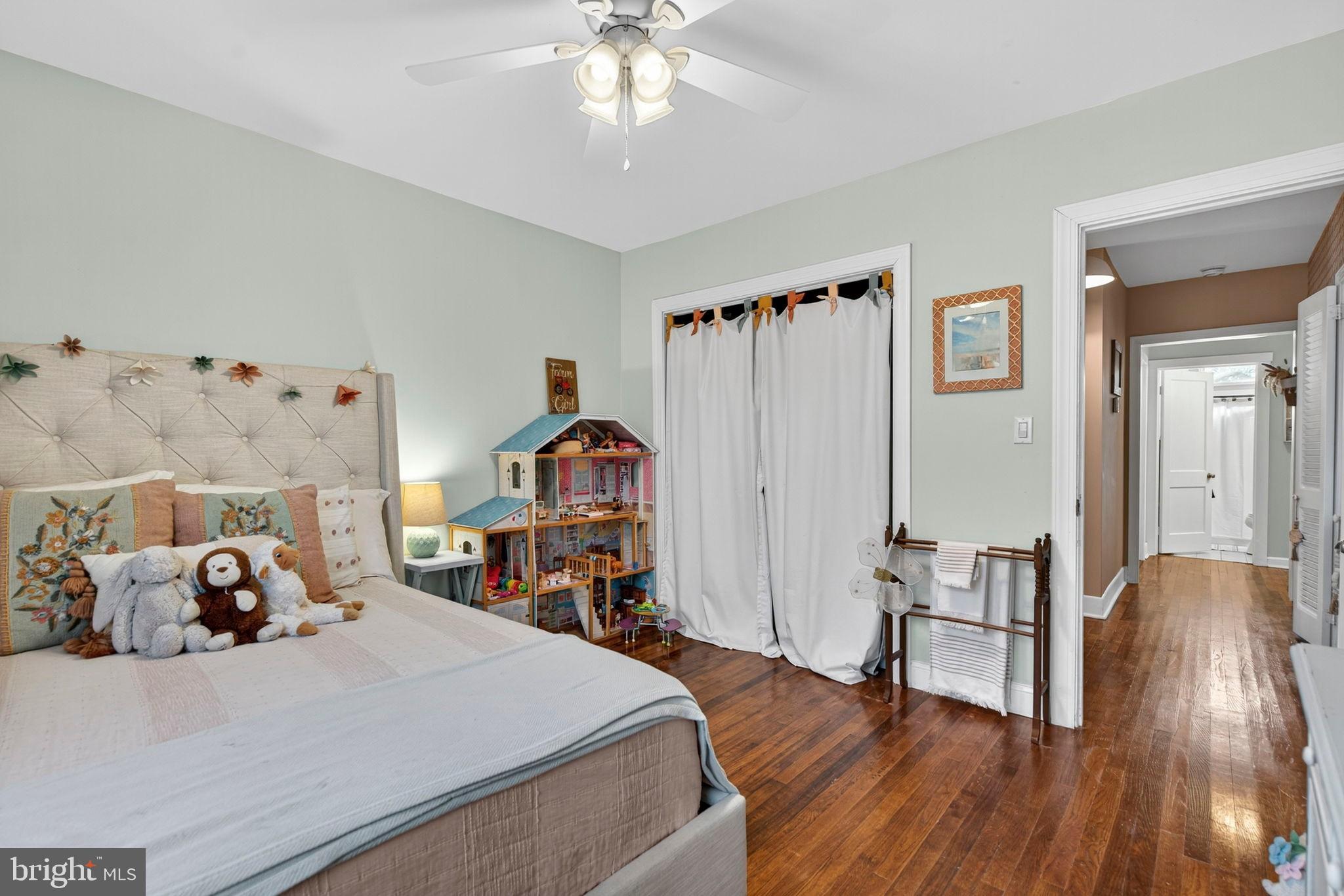 18321 Carrico Mills Road Stevensburg, VA 22741 - Photo 39 of 62 a bedroom with a bed and a chandelier