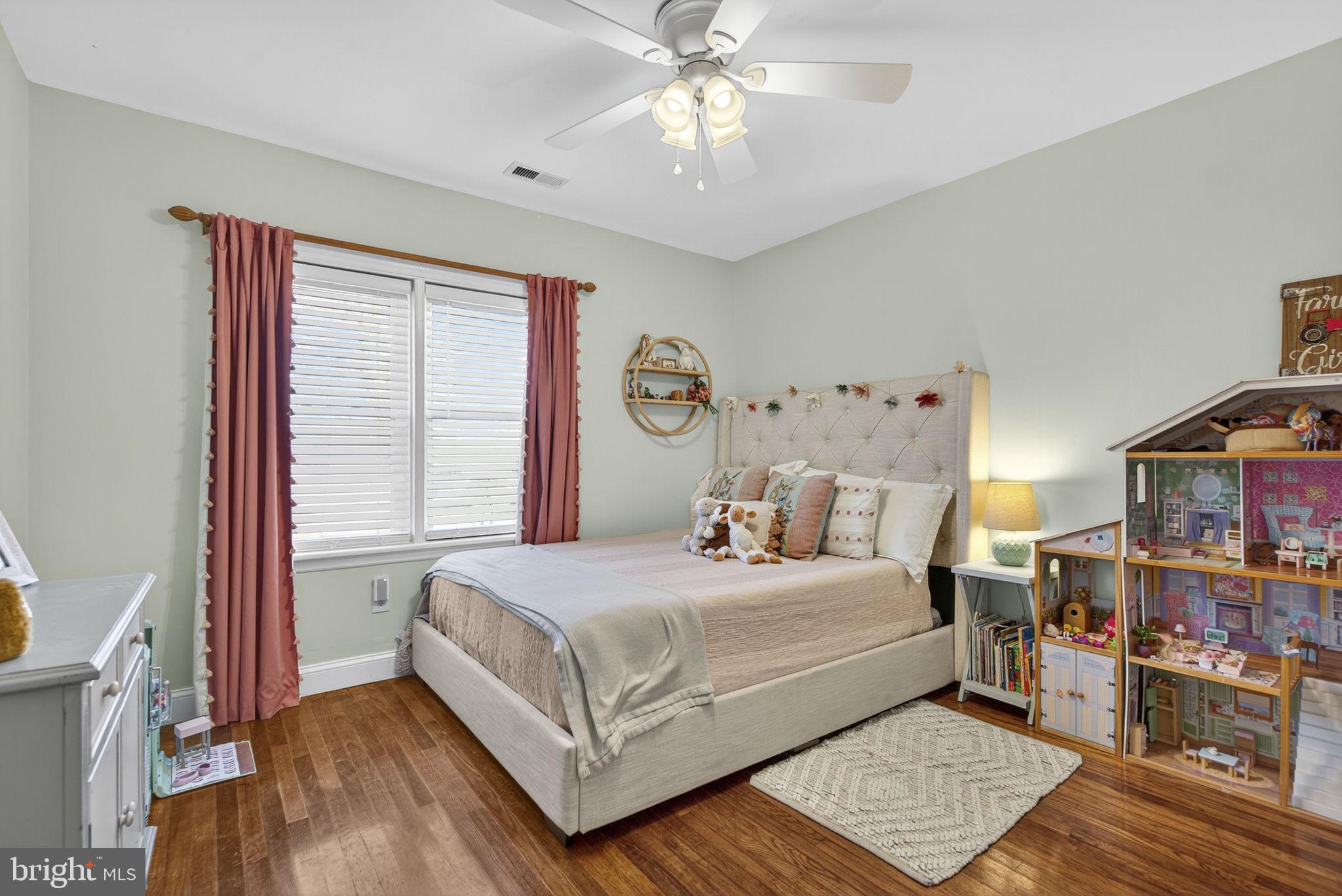 18321 Carrico Mills Road Stevensburg, VA 22741 - Photo 40 of 62 a bedroom with a bed and a book shelf