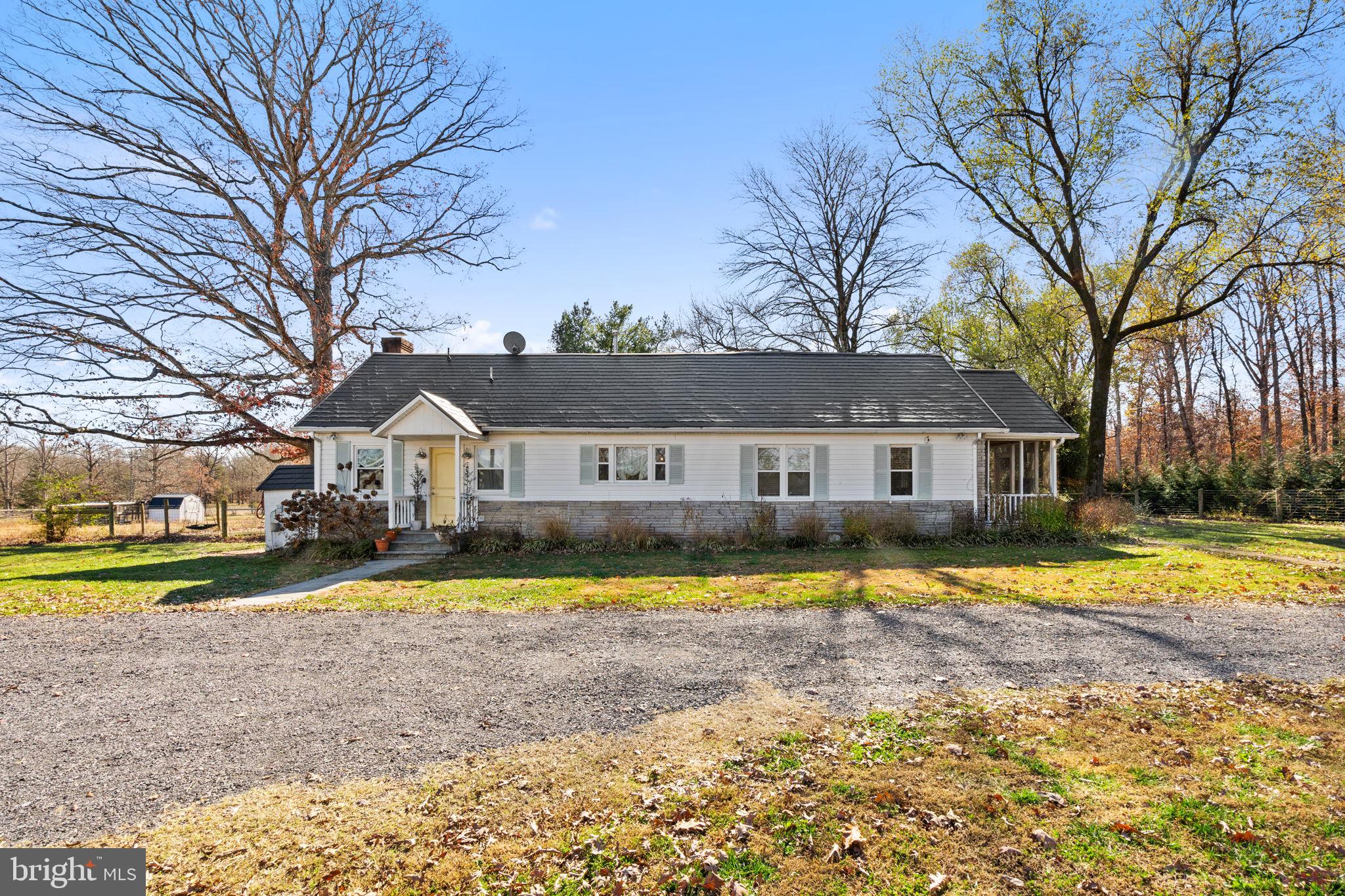 18321 Carrico Mills Road Stevensburg, VA 22741 - Photo 7 of 62 a view of a house with a big yard and large trees