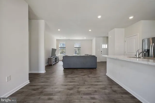a view of kitchen and living room with wooden floor