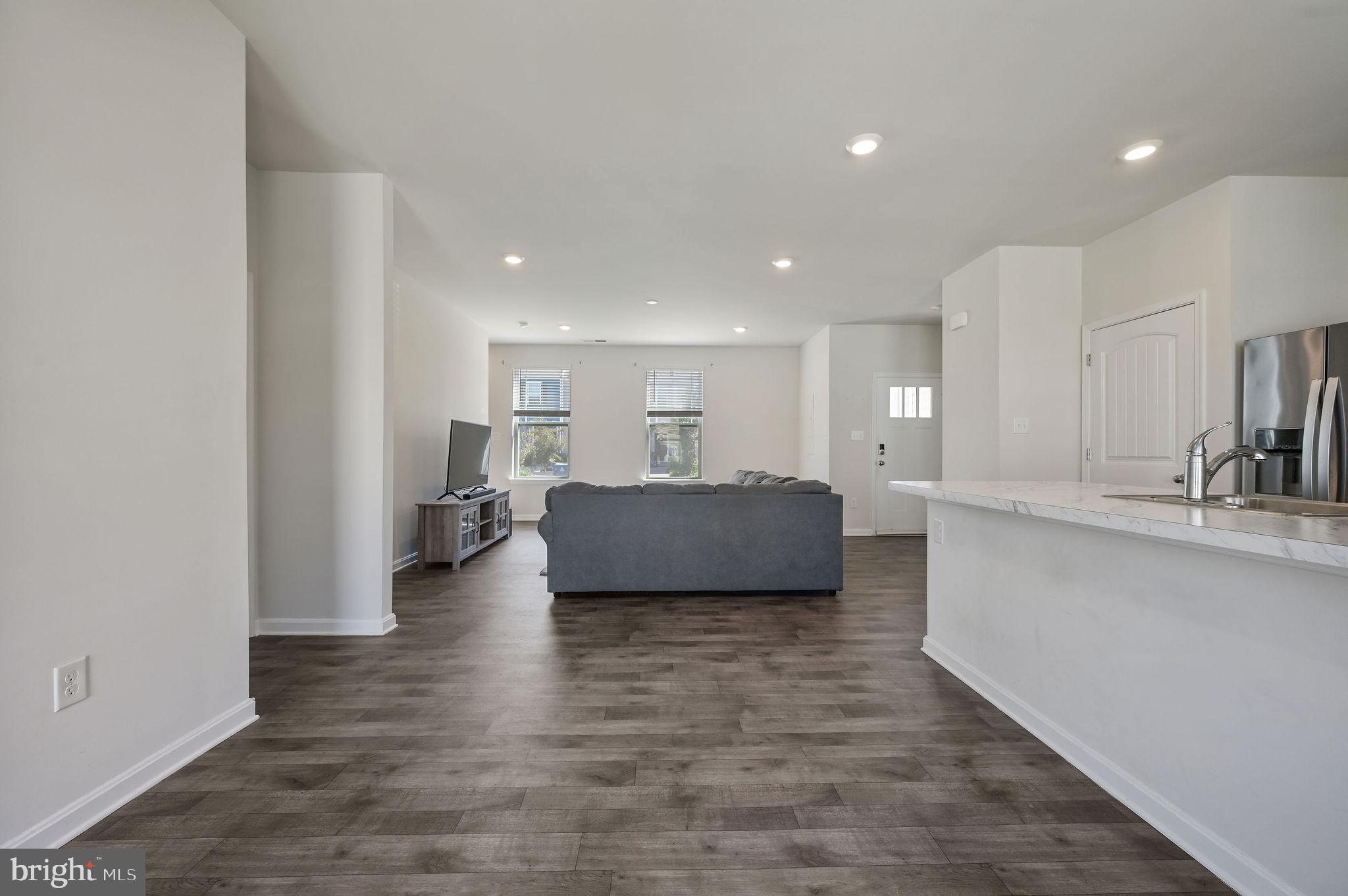 49 Citrus Drive Camden Wyoming, DE 19934 - Photo 13 of 27 a view of kitchen and living room with wooden floor