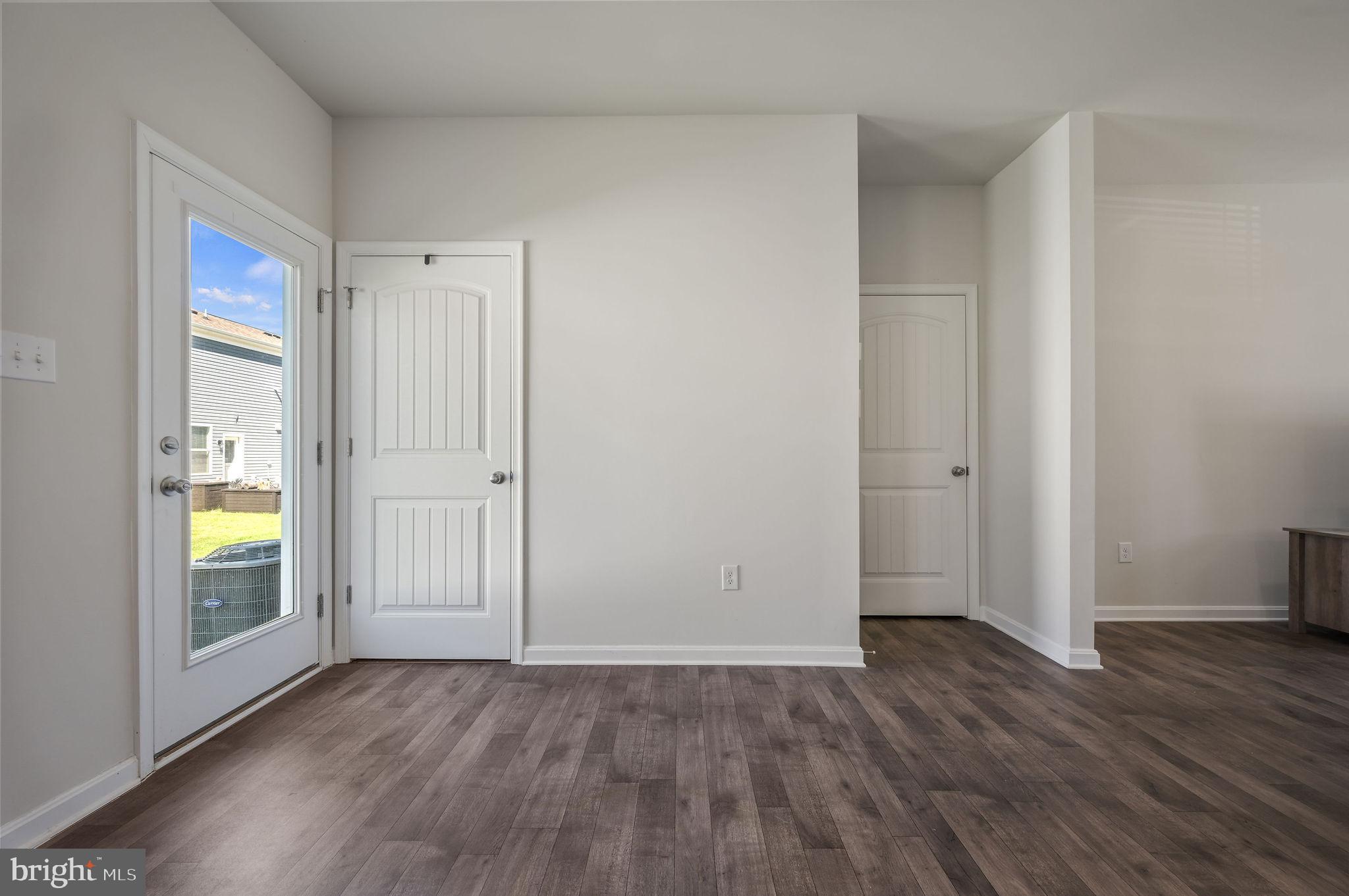 49 Citrus Drive Camden Wyoming, DE 19934 - Photo 14 of 27 an empty room with wooden floor and windows