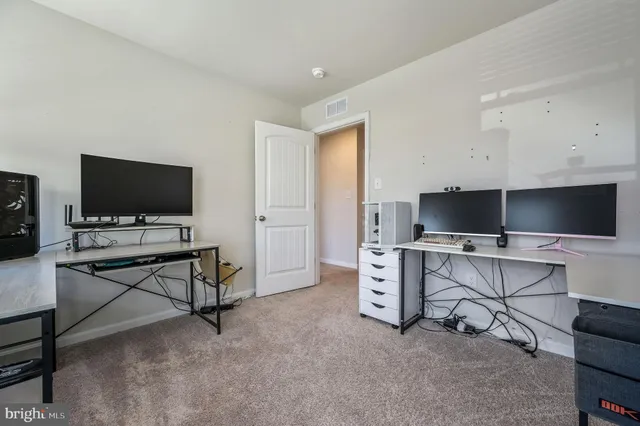 a view of a livingroom with workspace and a window