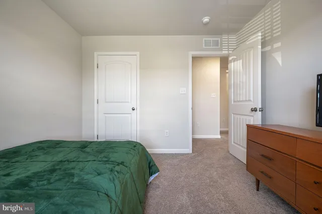 a bedroom with a bed and a dresser