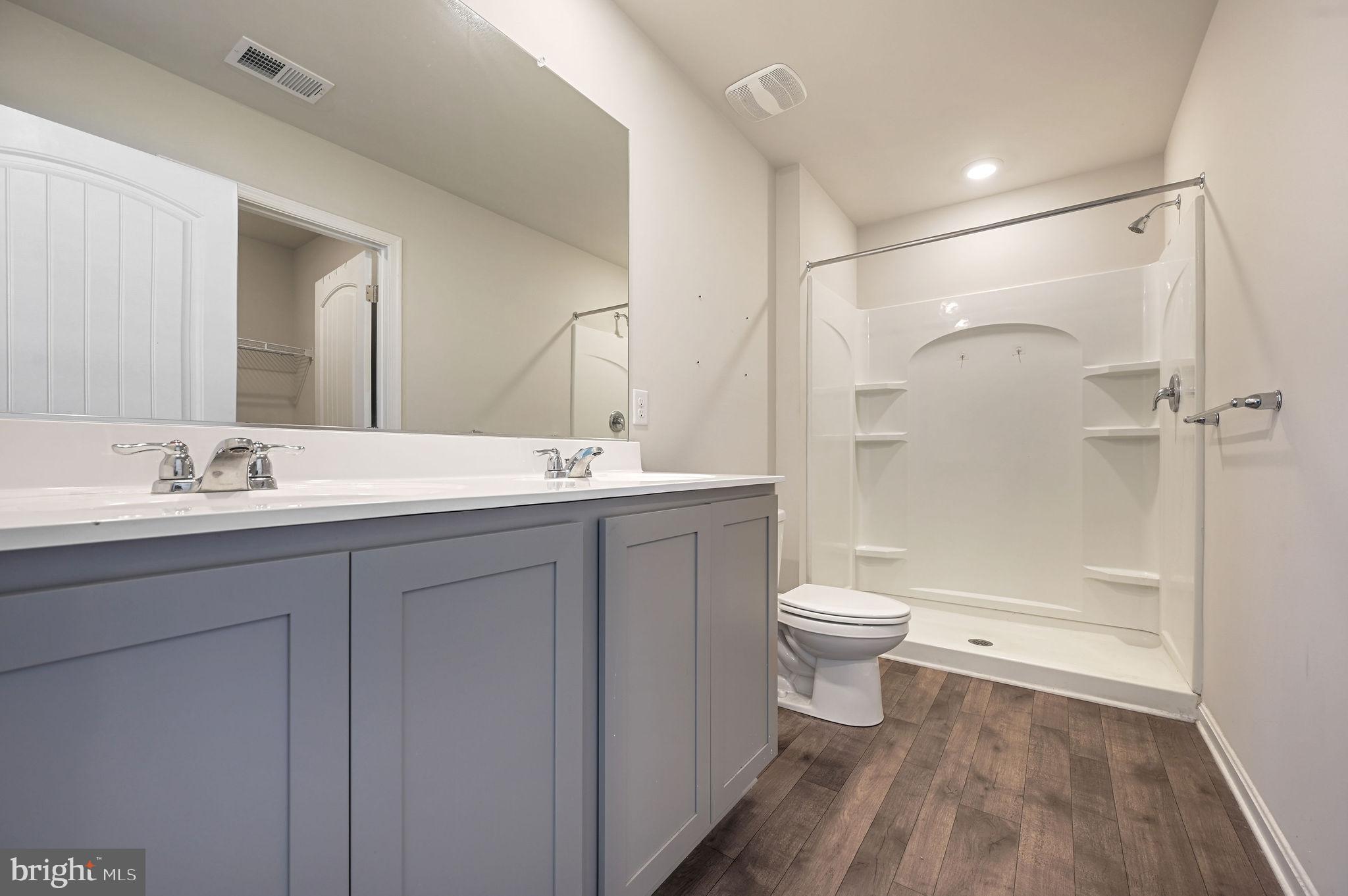49 Citrus Drive Camden Wyoming, DE 19934 - Photo 26 of 27 a bathroom with a double vanity sink toilet and shower