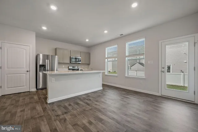 a view of kitchen with wooden floor and electronic appliances