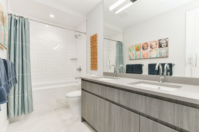 a bathroom with a granite countertop sink mirror toilet and bathtub