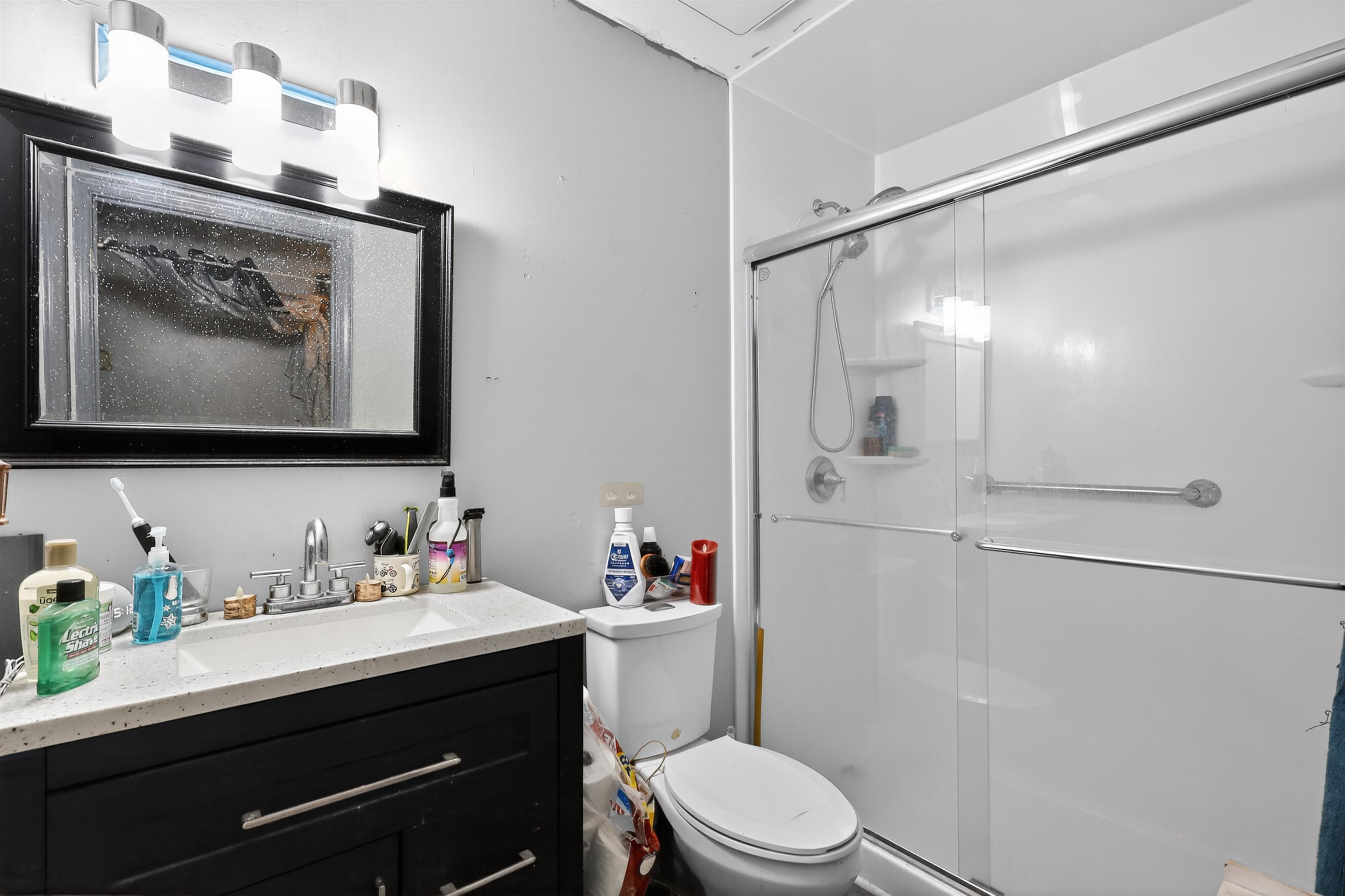 130 Cornell Road St. Augustine, FL 32086 - Photo 16 of 24 a bathroom with a sink vanity mirror and toilet