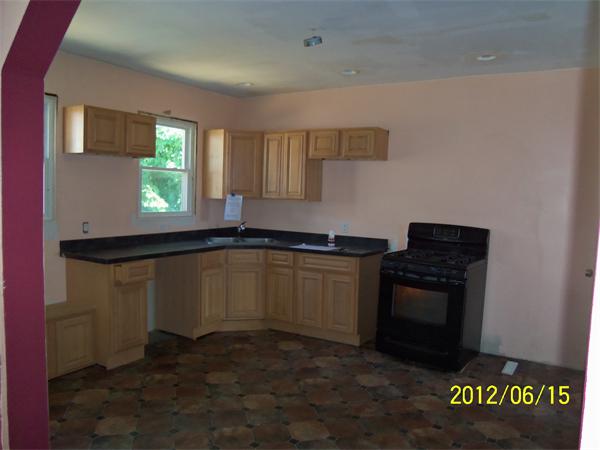 36 Branch Street Fall River, MA 02721 - Photo 3 of 8 a kitchen with a sink and a stove top oven