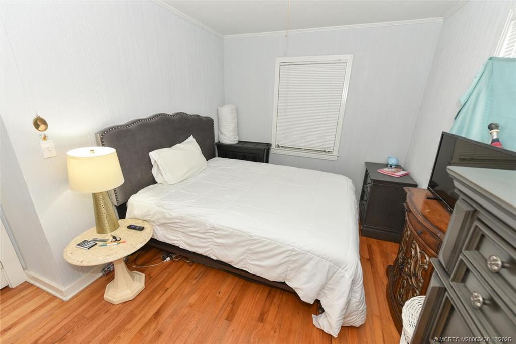 817 Southwest St Lucie Crescent Stuart, FL 34994 - Photo 12 of 25 a bedroom with a bed and a table in it