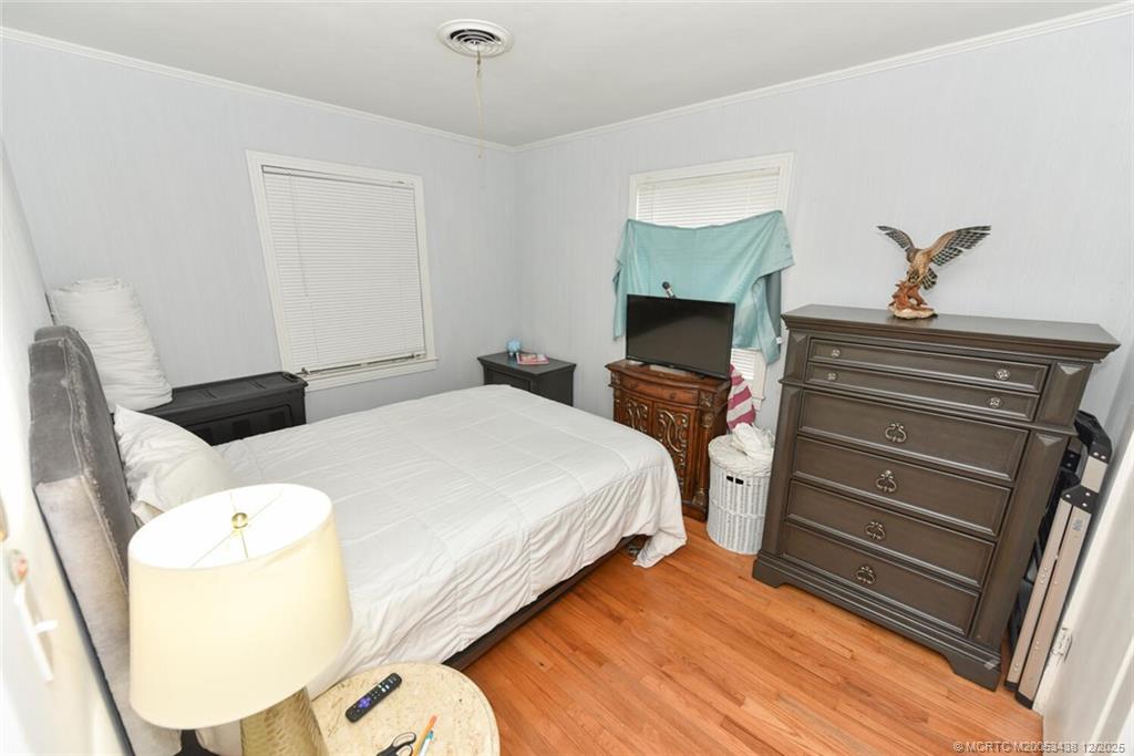 817 Southwest St Lucie Crescent Stuart, FL 34994 - Photo 13 of 25 a bedroom with a bed and a chandelier