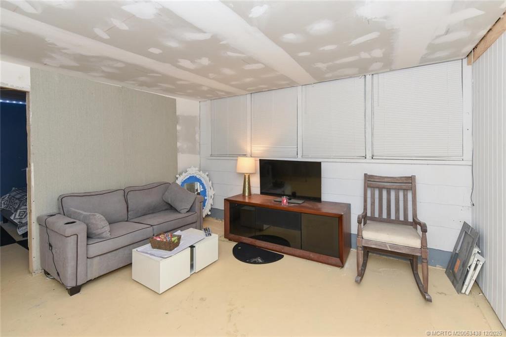 817 Southwest St Lucie Crescent Stuart, FL 34994 - Photo 15 of 25 a living room with furniture and a flat screen tv