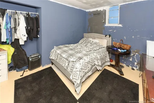 a bed sitting in a bedroom next to a window