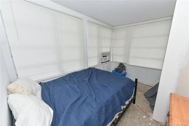 a bedroom with a bed and a chair