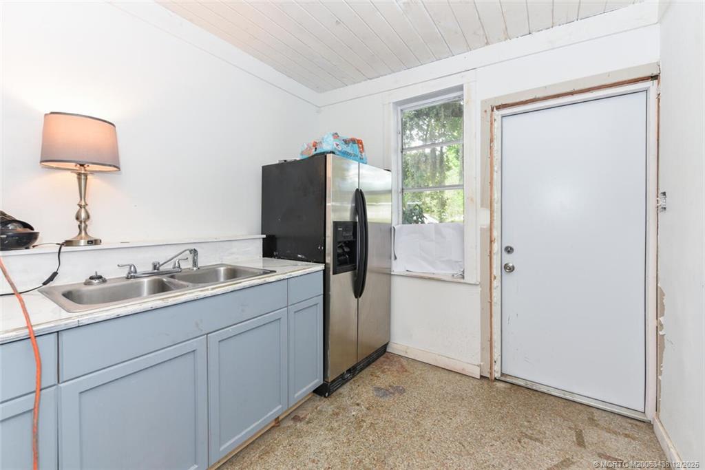 817 Southwest St Lucie Crescent Stuart, FL 34994 - Photo 18 of 25 a kitchen with a sink and refrigerator