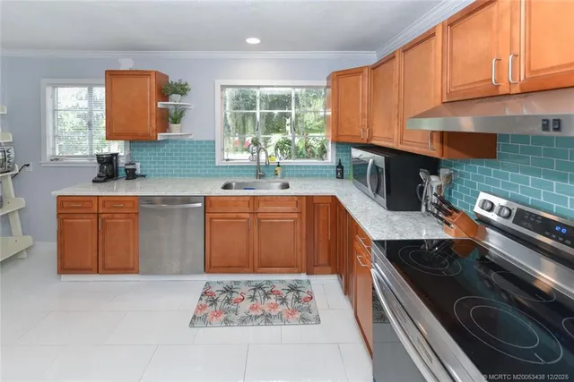 a kitchen with a sink stove and cabinets