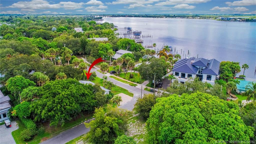 817 Southwest St Lucie Crescent Stuart, FL 34994 - Photo 3 of 25 an aerial view of a house with a yard and lake view