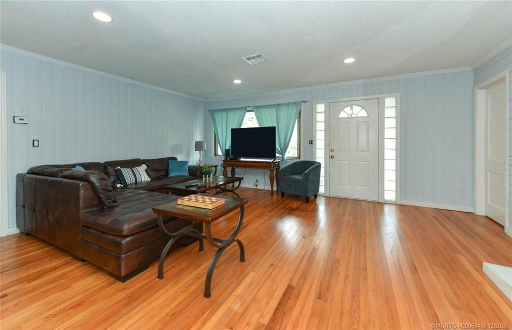 817 Southwest St Lucie Crescent Stuart, FL 34994 - Photo 7 of 25 a living room with furniture and a flat screen tv