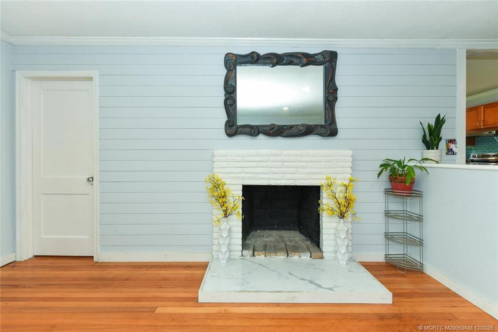 817 Southwest St Lucie Crescent Stuart, FL 34994 - Photo 8 of 25 a living room with a fireplace and a flat screen tv