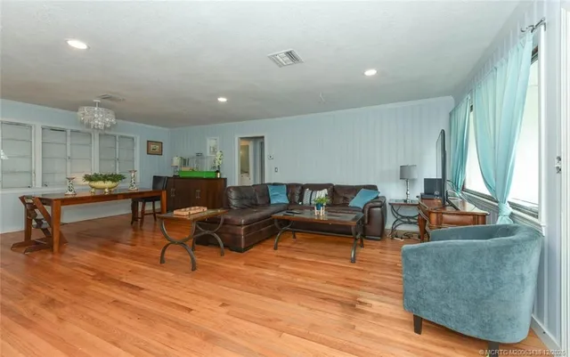 a living room with furniture and a wooden floor