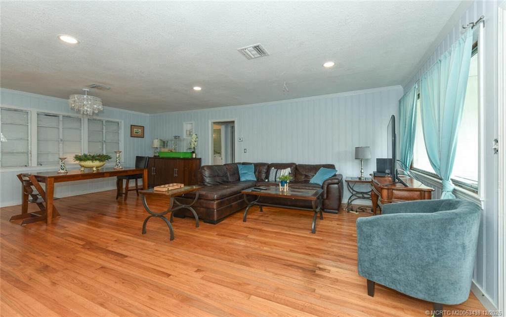 817 Southwest St Lucie Crescent Stuart, FL 34994 - Photo 9 of 25 a living room with furniture and a wooden floor