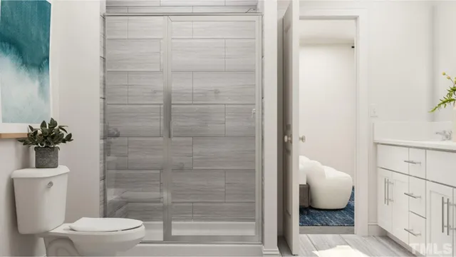 a bathroom with a toilet and a shower