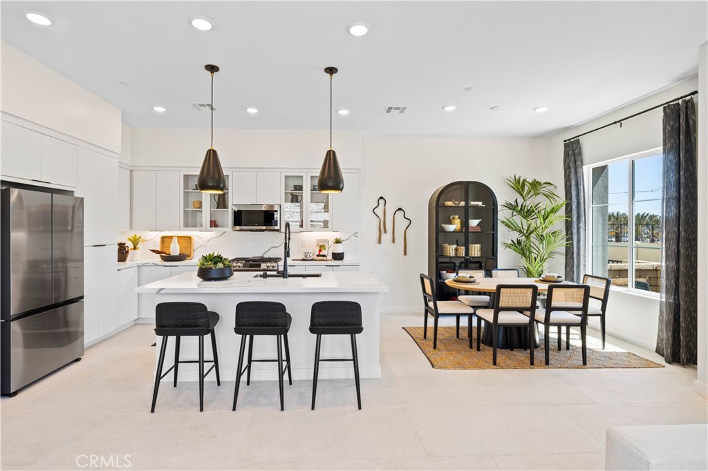 221 Roma Court Walnut, CA 91789 - Photo 5 of 22 a living room with stainless steel appliances kitchen island granite countertop furniture and a dining table