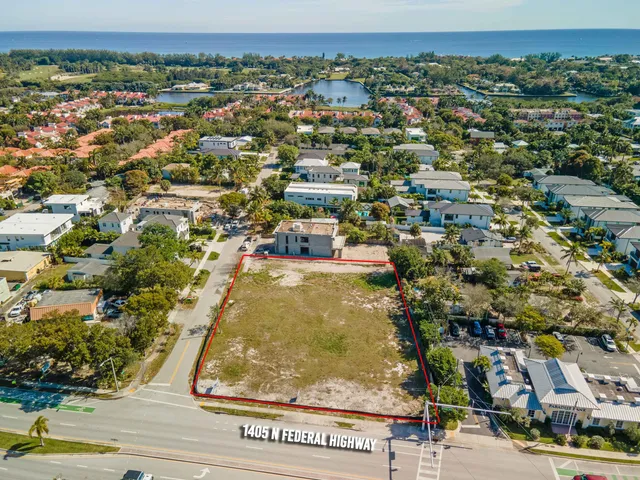 an aerial view of residential houses with city view