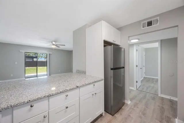 a kitchen with stainless steel appliances granite countertop a refrigerator and a sink