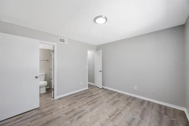 a view of an empty room and wooden floor