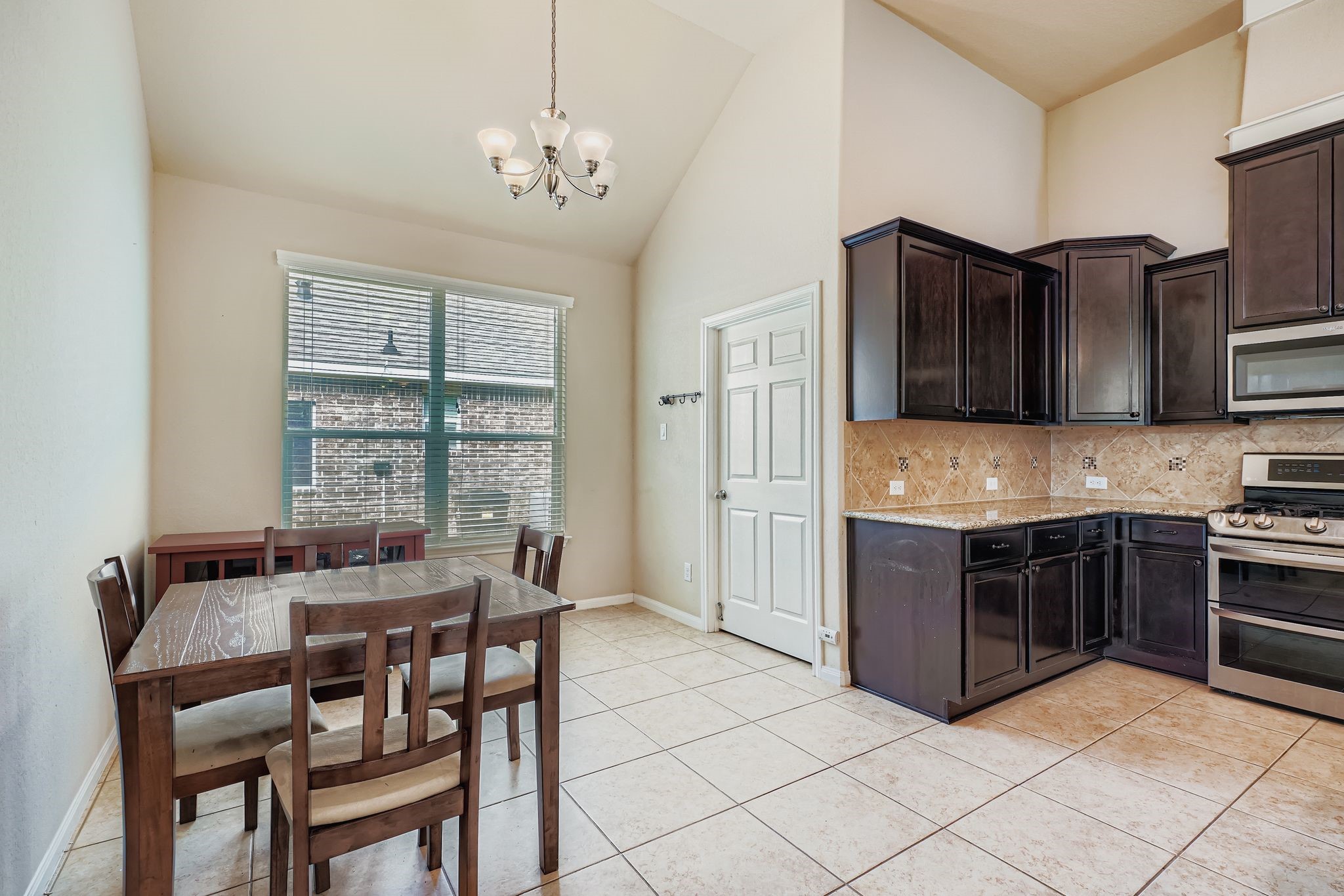 2227 Wembley Way Rosenberg, TX 77471 - Photo 13 of 27 a kitchen with stainless steel appliances granite countertop a stove a sink and a refrigerator