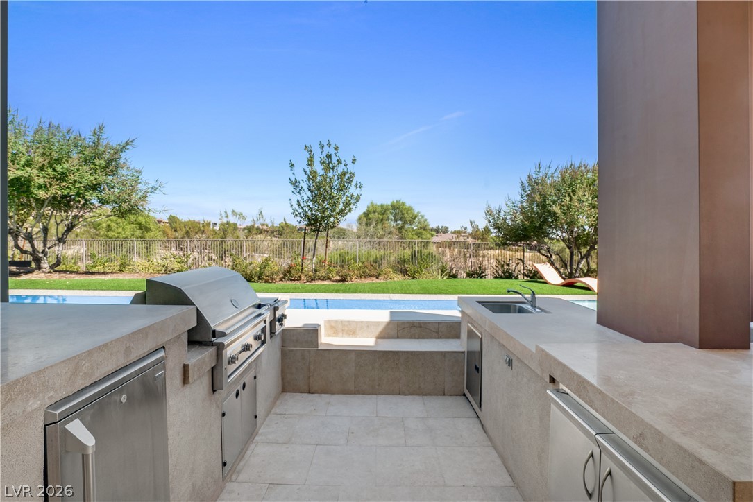 10 Ridge Blossom Road Las Vegas, NV 89135 - Photo 47 of 64 Fenced backyard featuring an outdoor kitchen and a patio