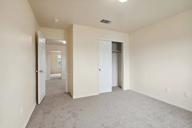 an empty room with a bathroom and a sink