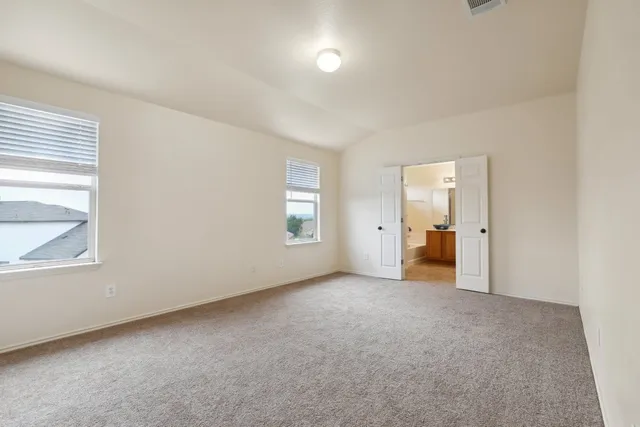 an empty room with windows and closet