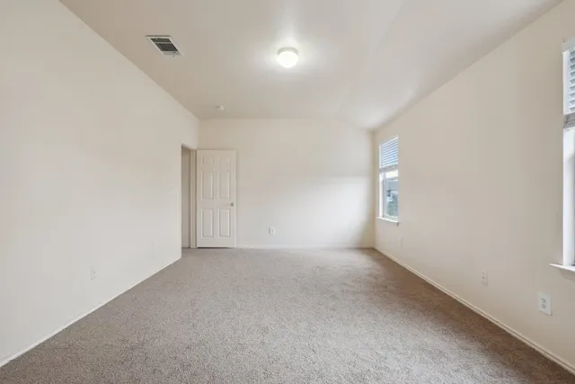 a view of an empty room and a window