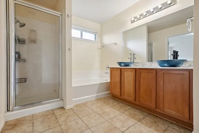 a bathroom with a sink mirror and a shower