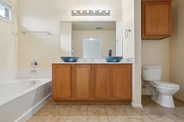 a bathroom with a sink a toilet and bathtub